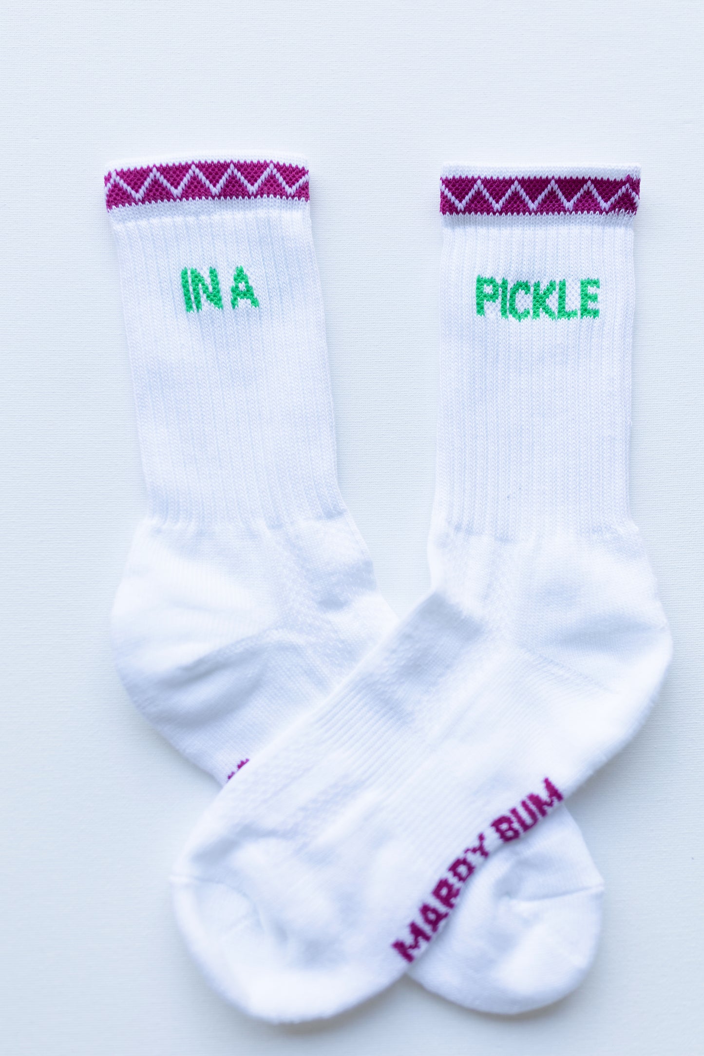 White sustainable sport socks with text 'IN A PICKLE' zig zag cuff details 
