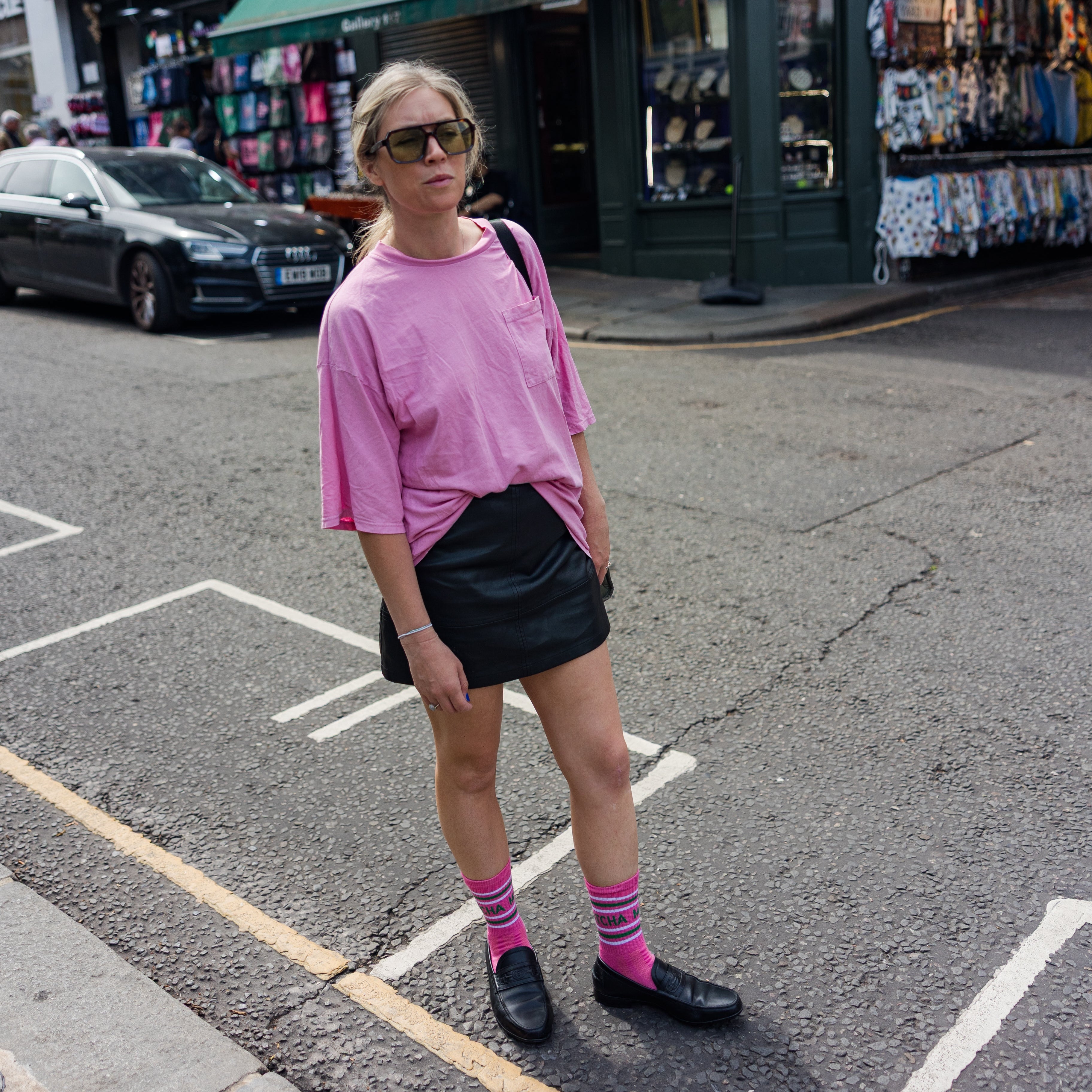 lady standing on portobello market in london wearing pink sport socks
